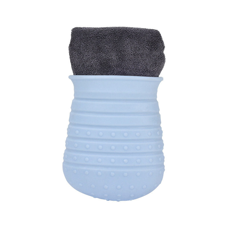 Blue textured washing cup with a gray towel on top on a white background