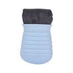 Blue textured washing cup with a gray towel on top on a white background