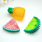 Colorful fruit-shaped textured toys on a white background