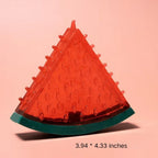 Triangular red object with textured surface on a pink background