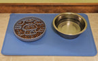 Pet food and water bowl on a blue mat with a tile floor background