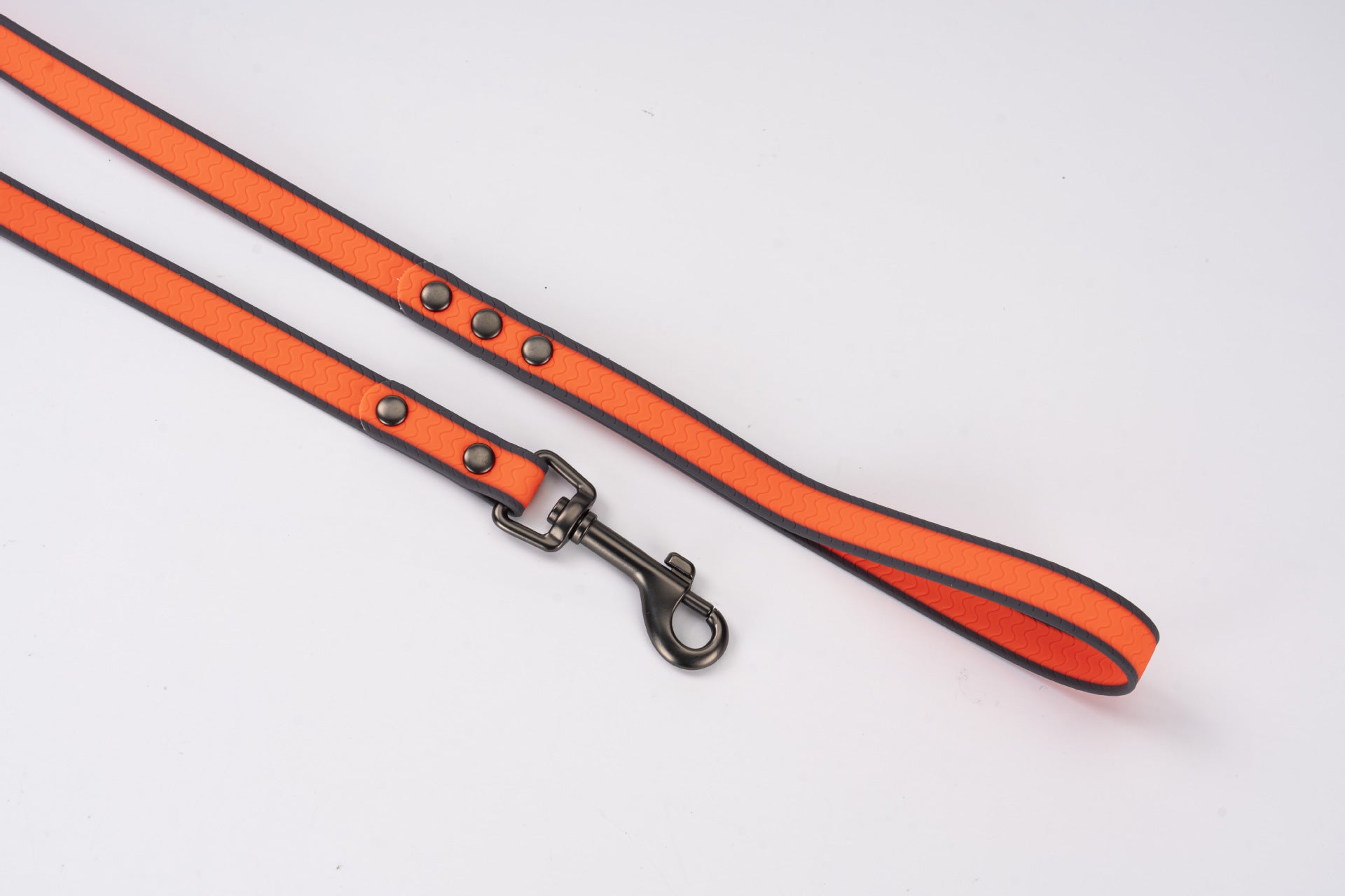 Red dog leash with black accents on a white background