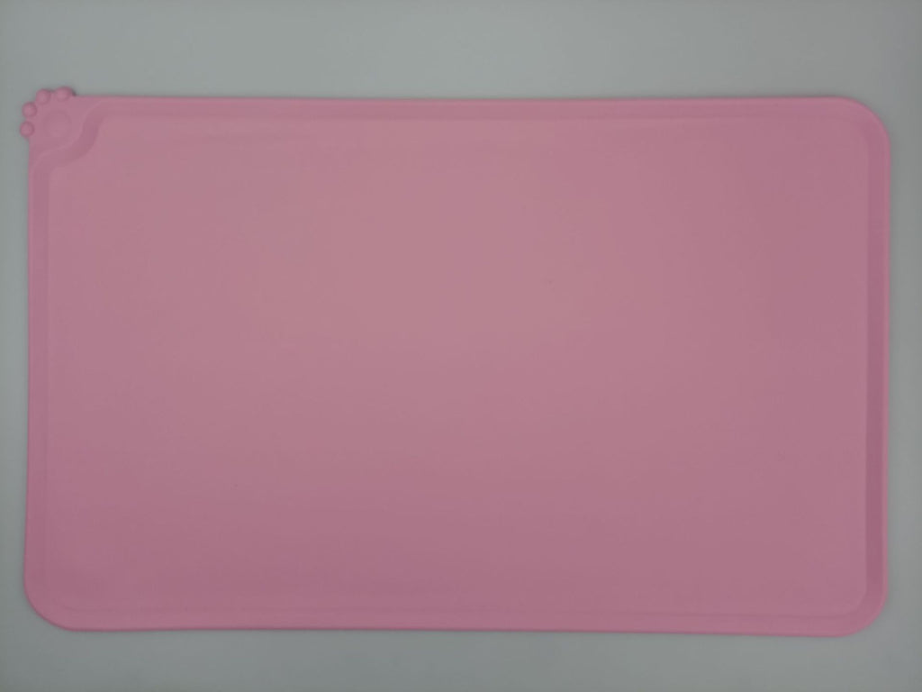 Pink rectangular silicone mat on a gray background