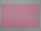 Pink rectangular silicone mat on a gray background
