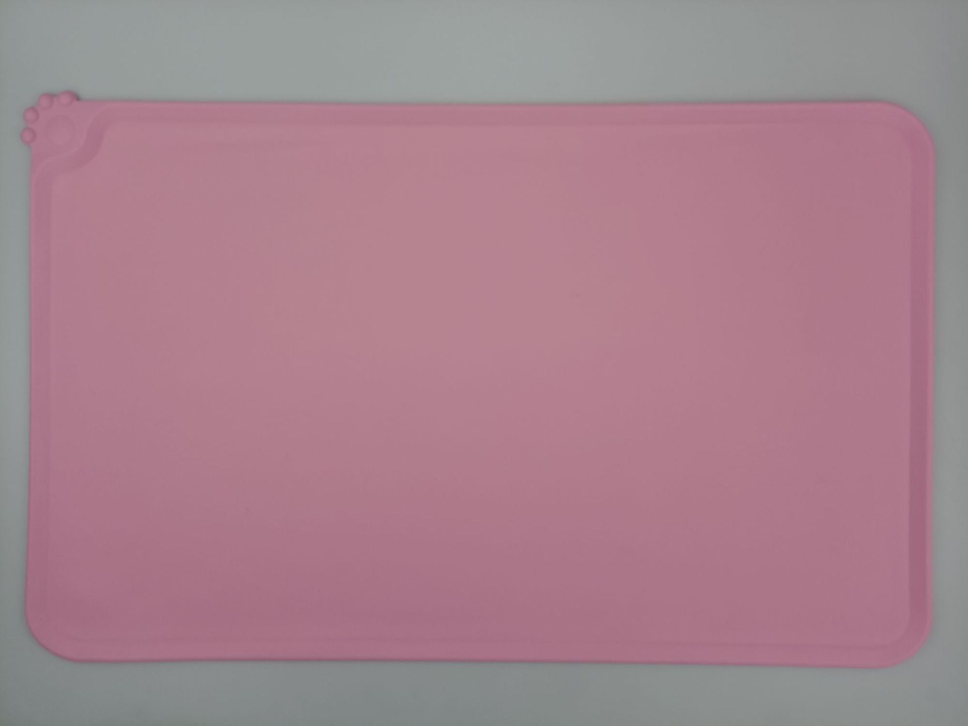 Pink rectangular silicone mat on a gray background