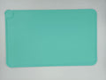 Teal silicone mat on a light gray background