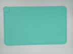 Teal silicone mat on a light gray background
