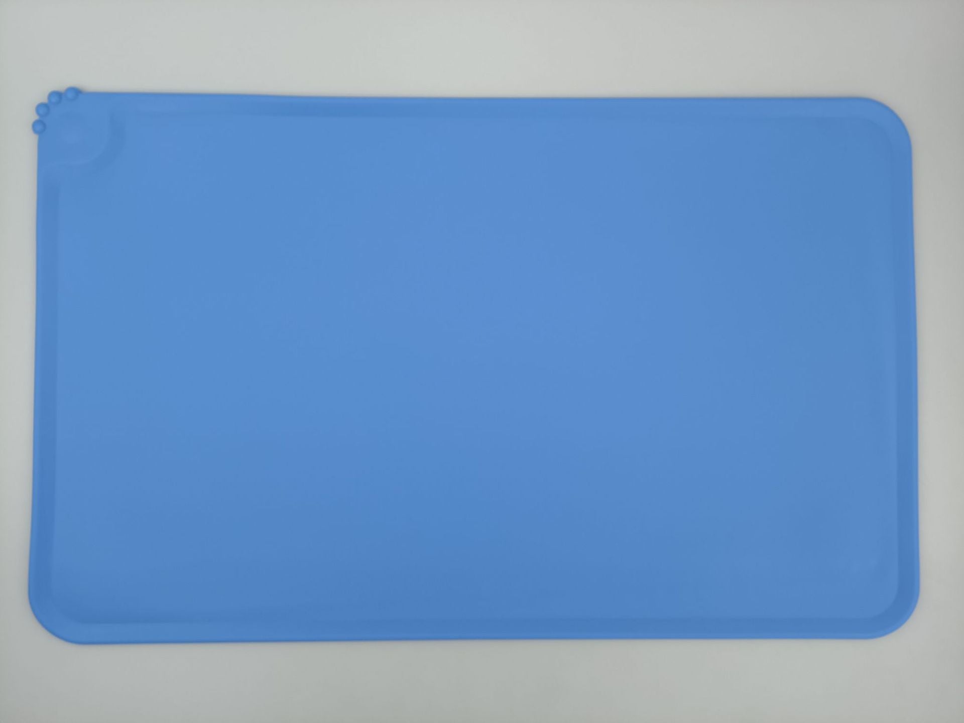 Blue silicone mat on a gray background
