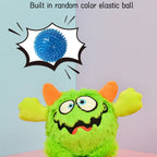 Green plush toy with orange ears and a blue elastic ball labeled 'Built in random color elastic ball'.
