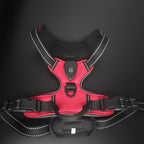 Red and black dog harness on a dark background