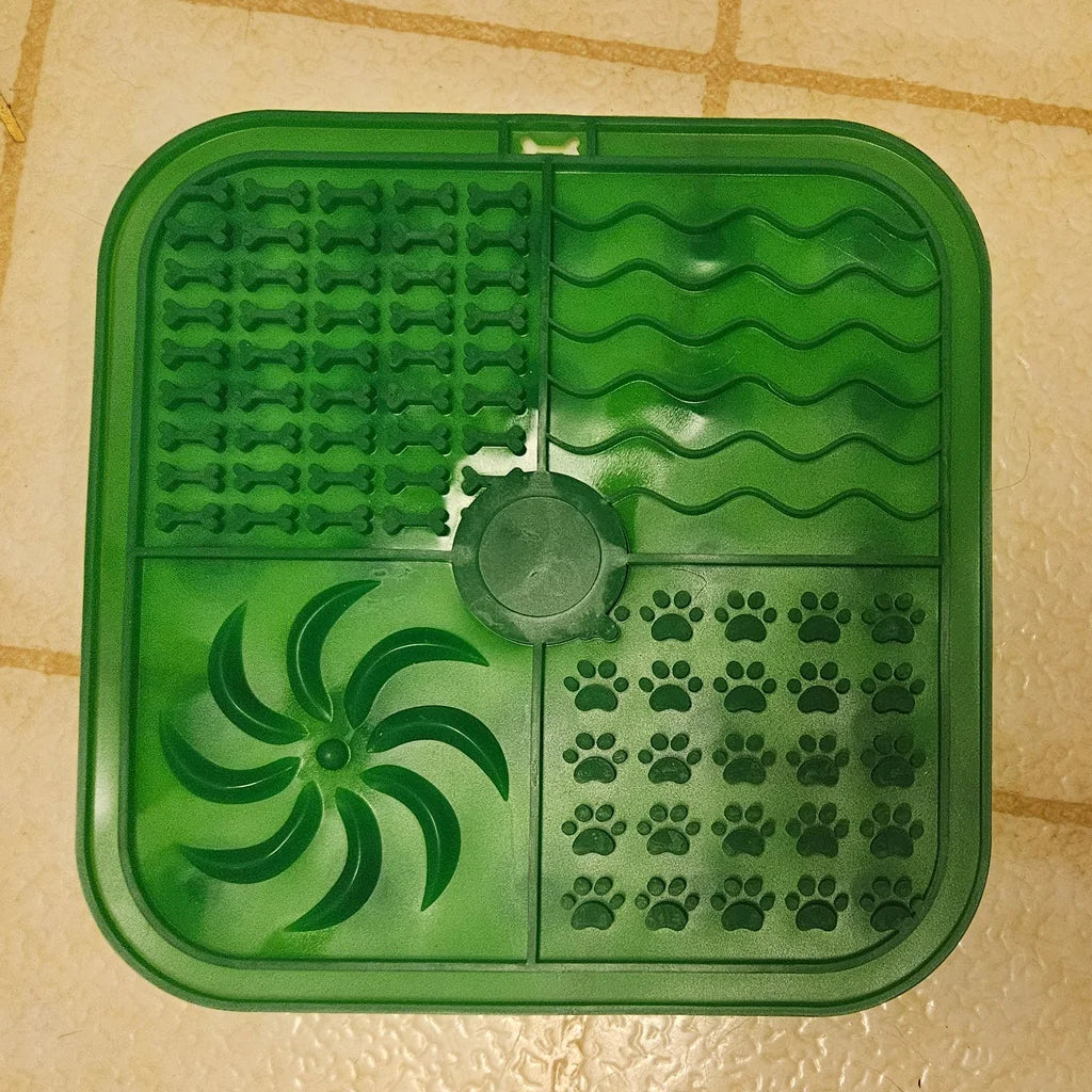 Green pet mat with paw print pattern on a tiled floor