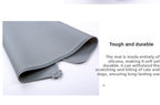 Gray silicone mat on a white background with text about its durability.