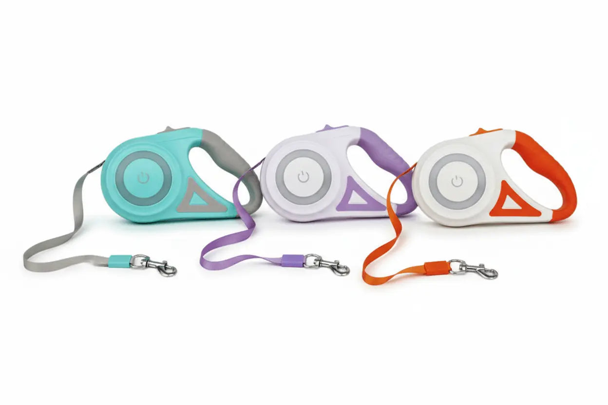 three colorful retractable dog leashes on a white background